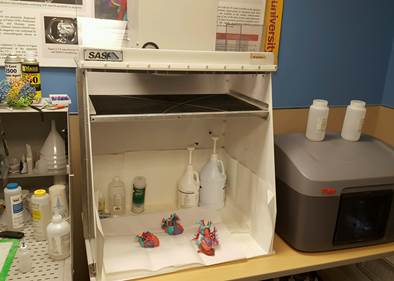 3D printed and color coded model hearts displayed in Sentry Air's Model 330 Ductless Spray Hood, installed in the Cardiac 3D Print Lab to capture aerosol sprays. No remodeling or additional ductwork was required.